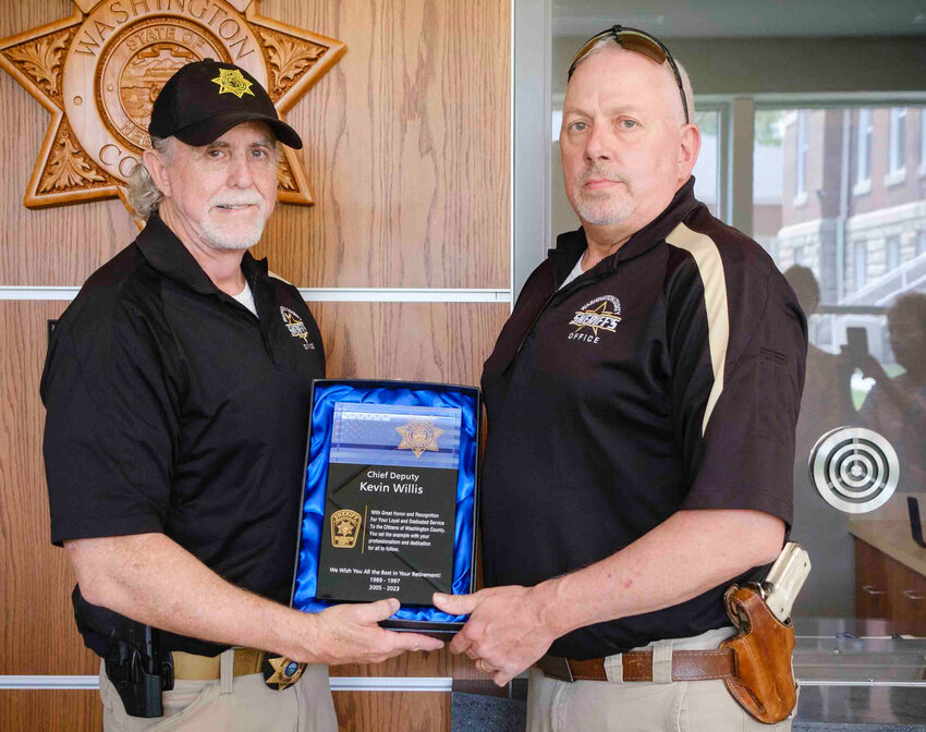 Chief Deputy Sheriff Kevin Willis, left, retired Wednesday, and celebrated with a plaque, handed by Sheriff Mike Robinson, and a get-together with family and friends at the Washington County Sheriff's Office.