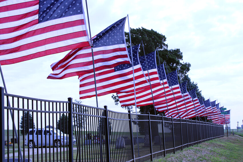 Volunteers helped to place dozens of flags along the Arlington Cemetery grounds prior to the Memorial Day ceremony.