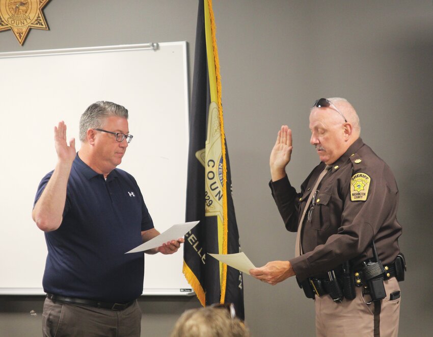 Mitch Robinson is sworn in as chief deputy sheriff by County Attorney Scott Vander Schaaf at the Washington County Sheriff's Office Tuesday afternoon.