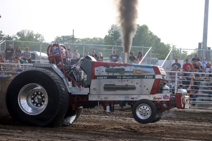 Mark Ulmer of Menno, S.D., makes his way down the track at the Washington County Fairgrounds during the annual Arlington Youth Sports' tractor pull Saturday evening.
