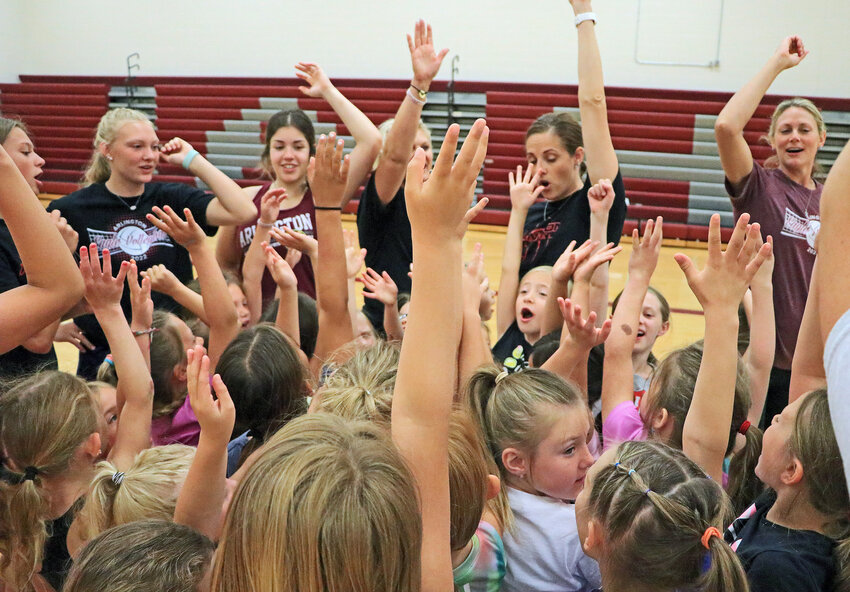 Arlington volleyball campers, players and coaches break the huddle Tuesday at AHS. About 100 girls in kindergarten through eighth grade took part in the Eagles' camp, which played out across three sessions, according to coach Stacy Nelson.