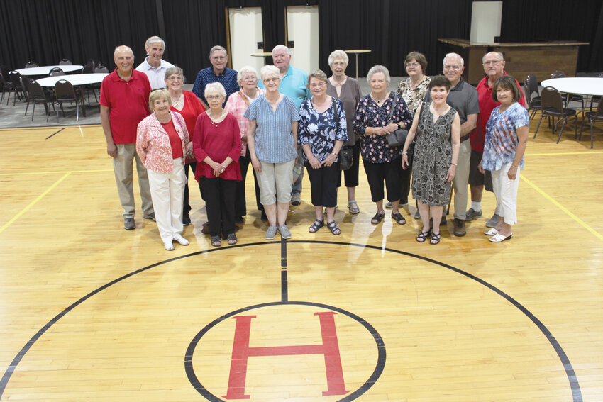 Herman public school alumni gather in the restored gym of the building they once took classes in. ANBE Events owners Gary and Theresa Riibe and Mark and Marissa Anderson repaired the building so the community could use it again as an events center.