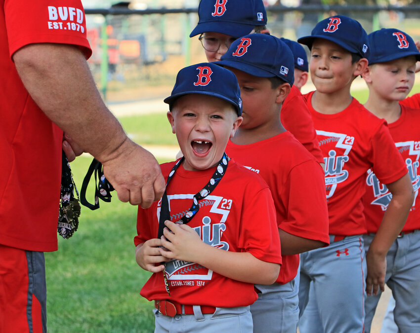 Grant Hahn of the Red Sox Rookies team reacts to receiving his Blair Little League championship medal Thursday at The Healthy Human Field at the Youth Sports Complex.
