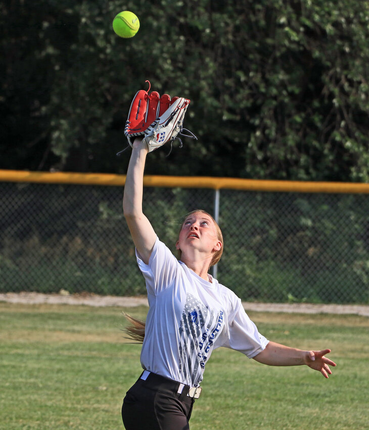 Softball player Taylor Nolan tracks down a fly ball Tuesday during a Pioneers team camp in Fort Calhoun.