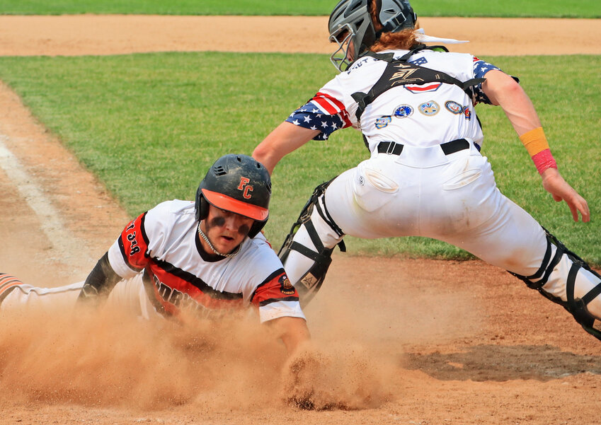 Zig Drywall Pioneer Ty Hallberg, left, slides in safe before Blair's Nate Wachter can turn and apply the tag at home plate Saturday in Fort Calhoun.