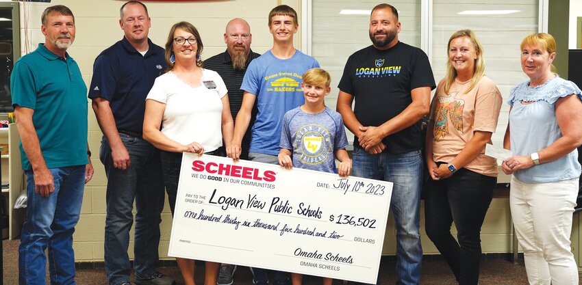 Scheels Associate Codi Oberg and her family were present at the Logan View School Board of Education meeting in July to deliver a check in the amount of #136,502 from the Scheels Foundation to help fund renovations to the elementary playground.  Pictured with Codi are (L-R) Kris Kremke, Chad Rebbe, Codi Oberg, Phil Oberg, Anthony Oberg, Brantley Oberg, Brandon Wobken, Christie Hasemann and Carrie Beacom.