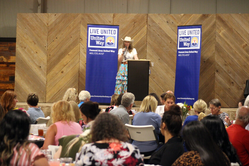 Christy Fiala, executive director of the Fremont Area United Way, speaks to a crowd during the 13th annual Hats Off To Literacy fundraiser Tuesday afternoon at the Washington County Fairgrounds.