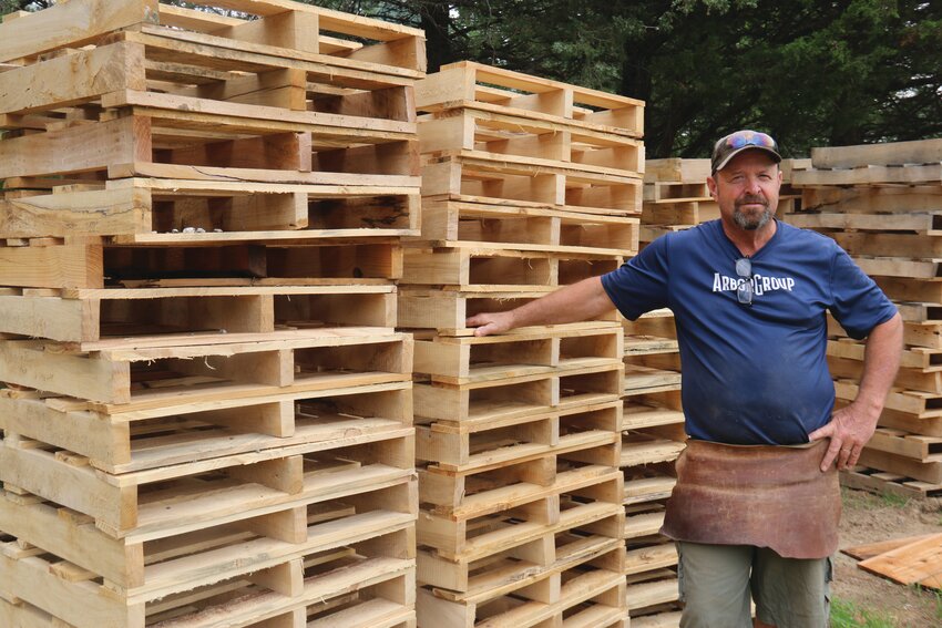 Mink builds wood pallets that he sells to 40 stores across the U.S. Most of the wood he works with comes from old trees and poles that would otherwise go to the dump.