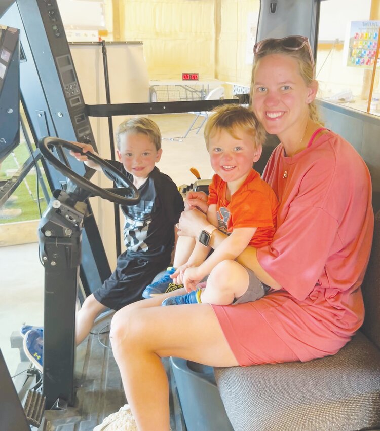 Rory and Knox Beckner enjoy the combine simulator at the Ag Education Center at the Burt County Fair.  The center began as a tribute to Lena