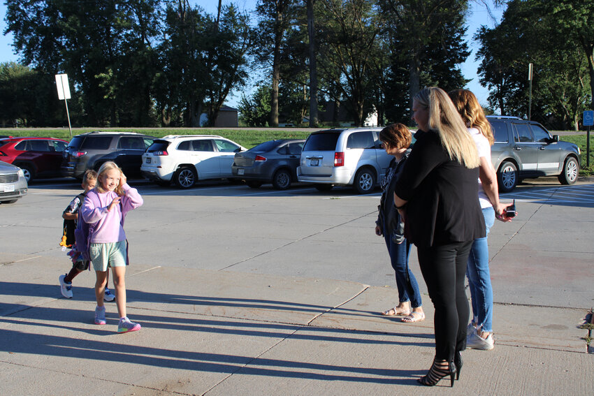 Staff, including Arlington Elementary principal Jacqueline Morgan, greet students Tuesday morning on the first day of school.