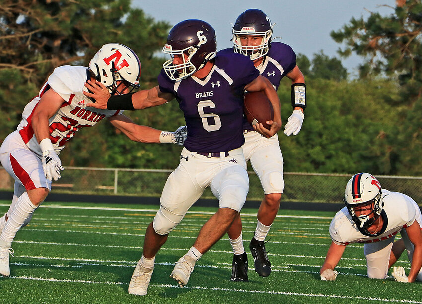 Blair junior back Brock Templar (6) evades a Norris tackler as teammate Crayton Macholan trails the play Friday at Krantz Field. Templar scored two touchdowns, but the Bears lost, 42-21.