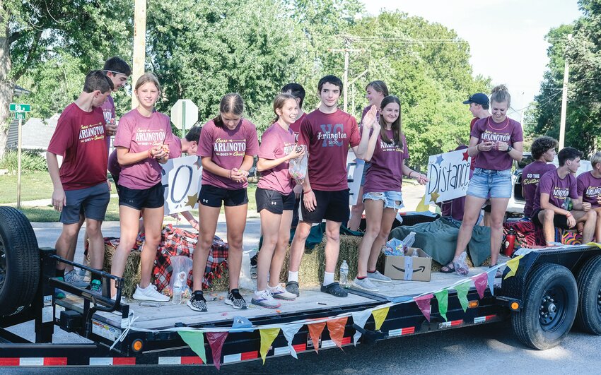 The Arlington cross country team makes their way down the parade route Sunday evening.