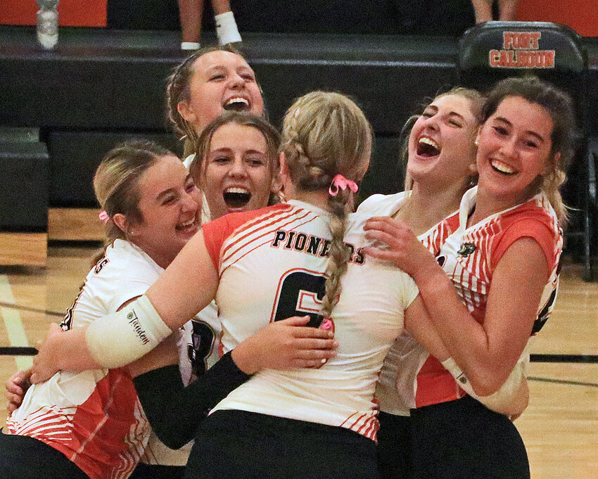 The Pioneers celebrate a 3-0 sweep of Arlington on Thursday at Fort Calhoun High School.