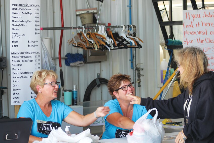Mary Kempcke (left) and Pat Rogers help a customer at the MCH Auxiliary Rummage Sale last year at the Blair Public Works building.
