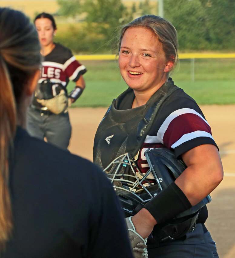 Arlington catcher Lilly Lang smiles on her way back to the dugout Thursday at the RVR Bank Sports Complex.
