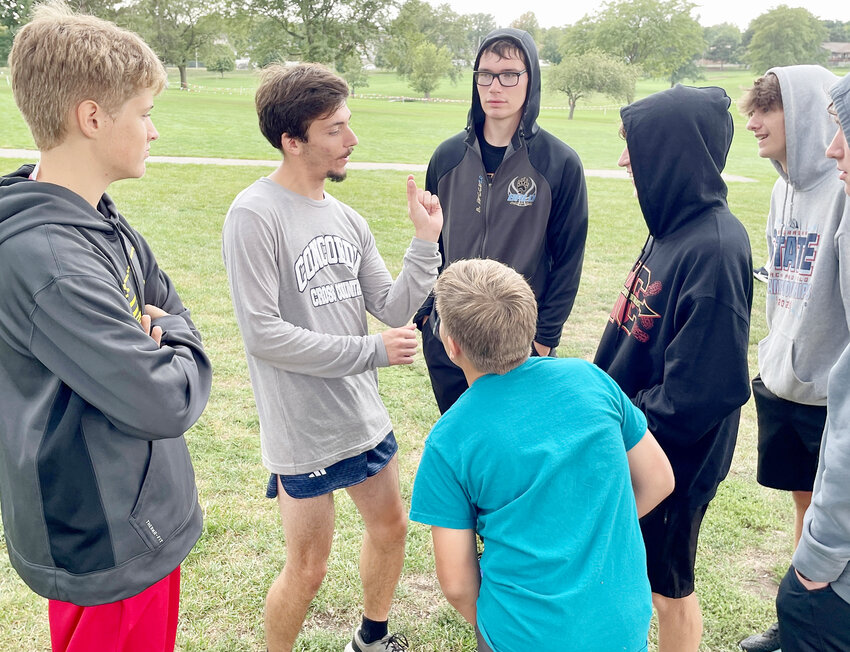 Caleb Schlichting was happy to take the time to visit with his former High school teammates after he ran in competition.