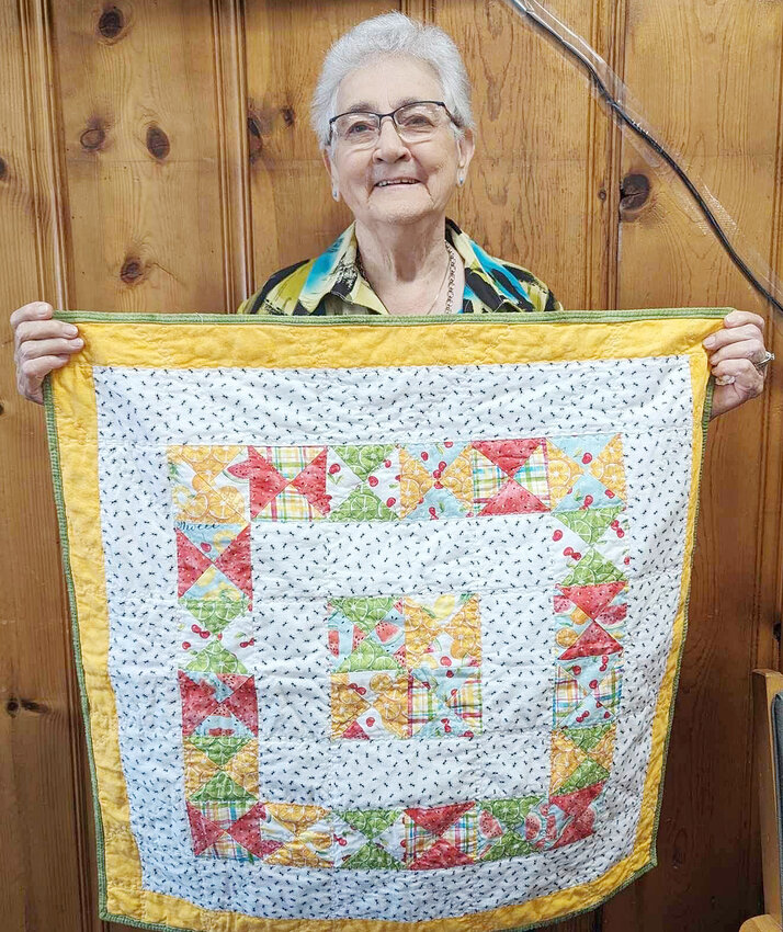 Lila Nelson and the quilt to be proud of.