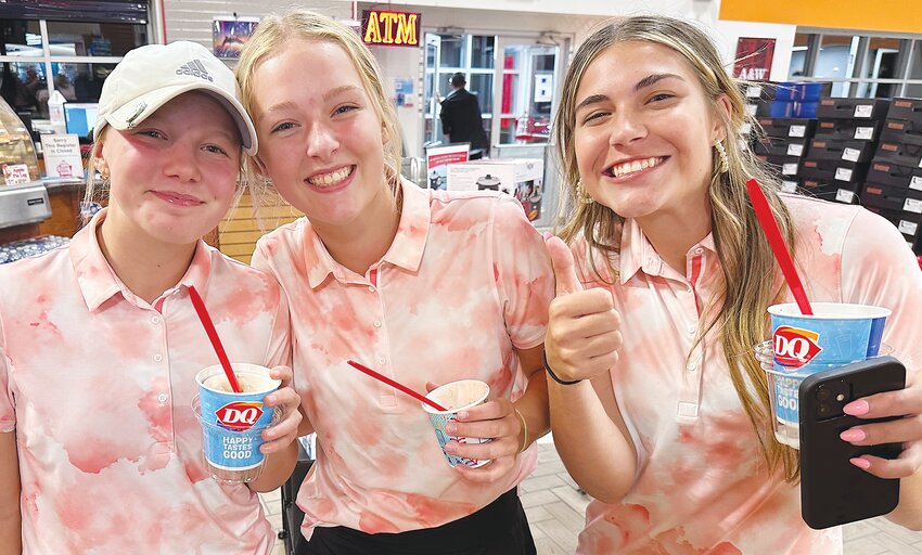 Emma Anderson, Kara Selken and Valerie Lierman celebrate with a sweet treat after tying for first place in the the Oakland-Craig Quad golf event on Thursday.