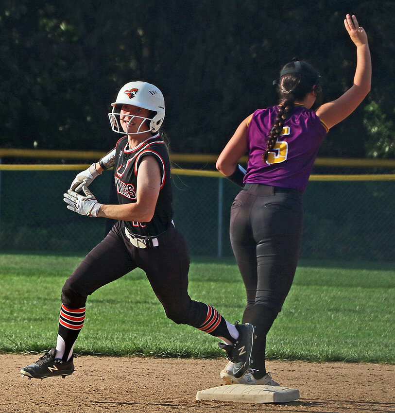 The Pioneers' Taylor Nolan, left, runs through second base on her way to third against Tekamah-Herman on Monday in Fort Calhoun.