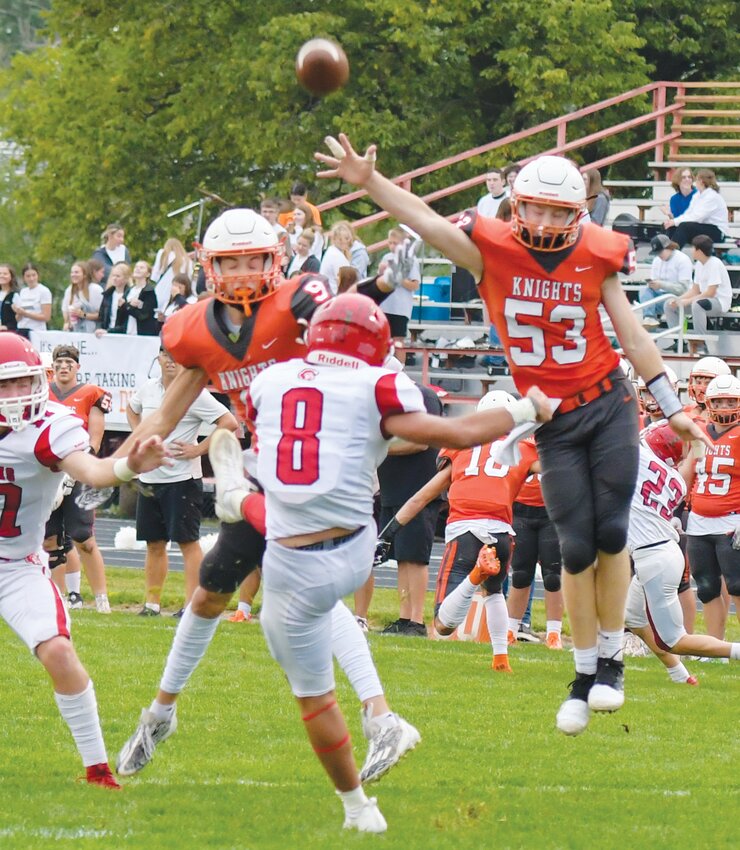 #53 Nolan Magnusson goes airborne in an attempt to block the Cedar Catholic punt.