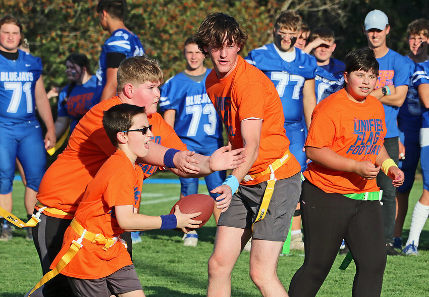 Gerald Taylor, from left, Joey Robinson, Sam Genoways and Reilly Rauterkaus of the Fort Calhoun Unified Flag Football team work together Friday at Ashland-Greenwood High School.