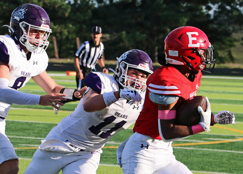 Blair defenders Ben Holcomb, left, and Brady Brown, middle, chase down an Antler runner Friday at Elkhorn High School.