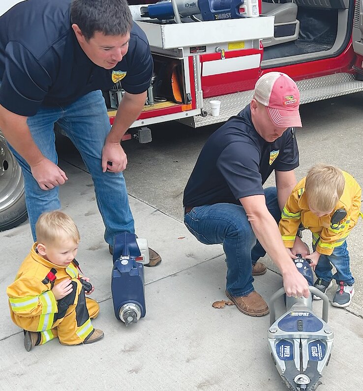 OVFRD firefighters (left) Danny Beavers and (right) Trent Elsasser showed the future firefighters (their sons) how to use the jaws of life on a pop can. Some say you can never start too early.