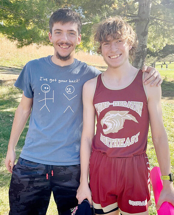 It is always a good feeling to have support from friends. Former LDNE student and teammate (right) Caleb Schlichting helped cheer (left)Chance Mock on while he competed at the State Cross Country Meet.