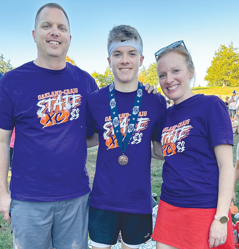 Coaches Henry and Megan Unwin had a great year and share the memory with the top runner Dawson Meyer who medaled at state in 7th place.