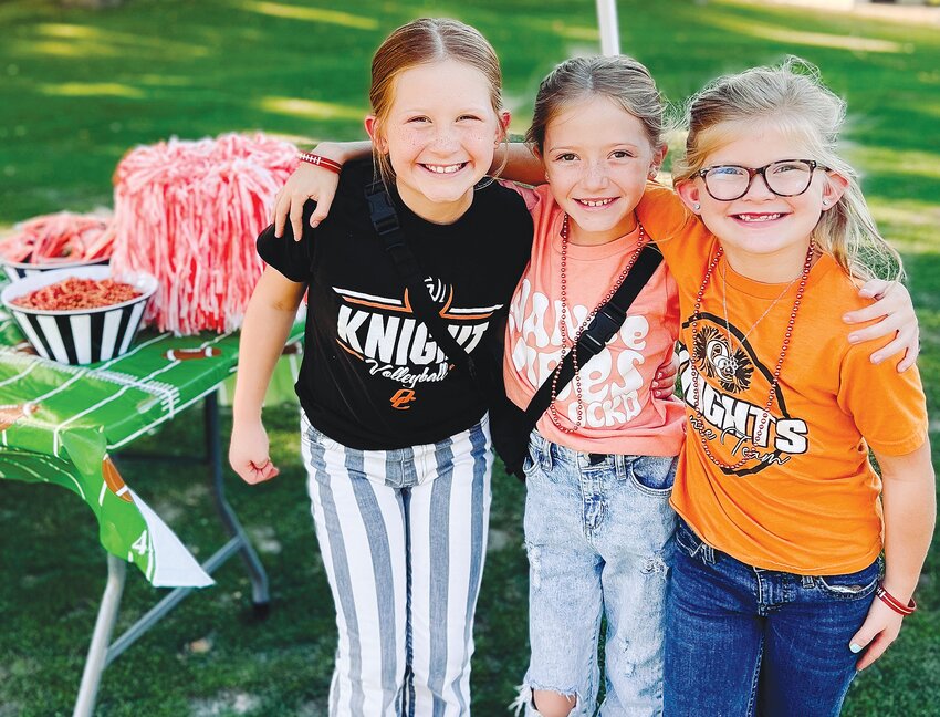 Willow Hartwell, Sutton Hartwell, and Waylon Hartwell are excited for the Knights football game following the Oakland-Craig PTO Tailgate Party.
