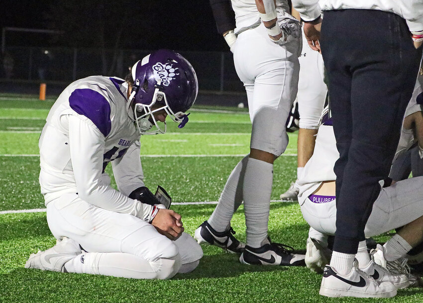 A disappointed Bode Soukup of the Blair Bears sits behind the postgame huddle Friday after a 30-28 playoff loss at Omaha Skutt.