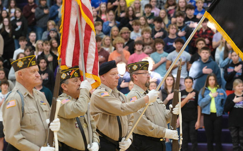 The Blair VFW 1251 Color Guard marches down the Blair High School gymnasium to post the Colors Friday during the Veterans Day ceremony.