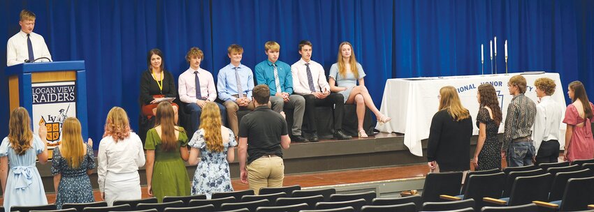 As part of the ceremony, Logan View National Honor Society inductees stand and recite the NHS Pledge before receiving their membership certificates and pins.