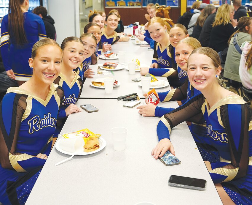 The Raider Dance Team pauses for a quick photo while enjoying their meal at the Winter Sports Kickoff last week.
