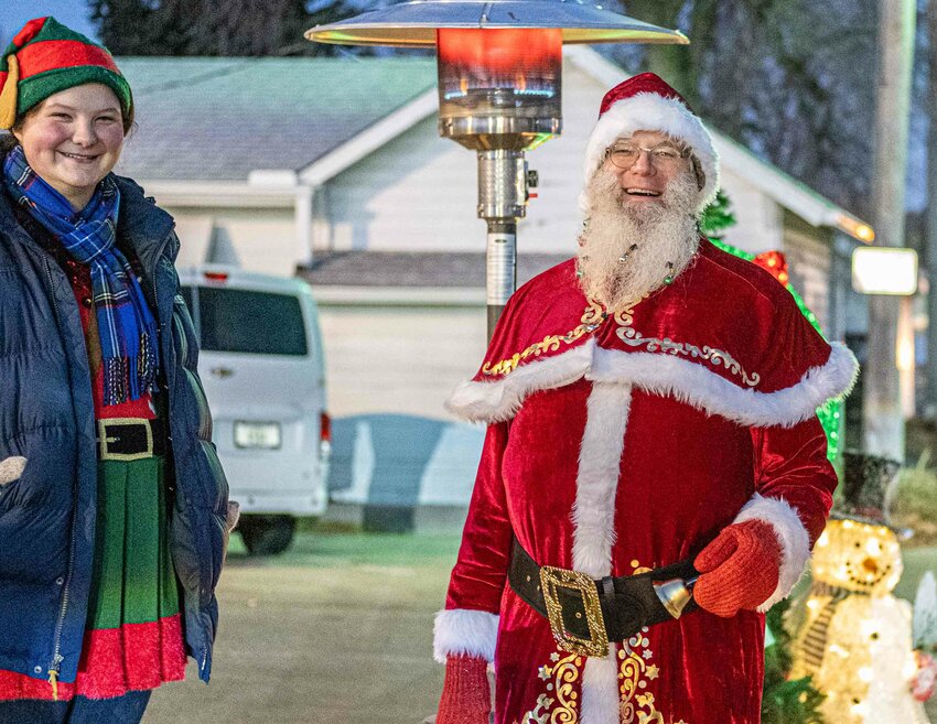 Santa and an elf greet customers at Christmas for the Coat last year.