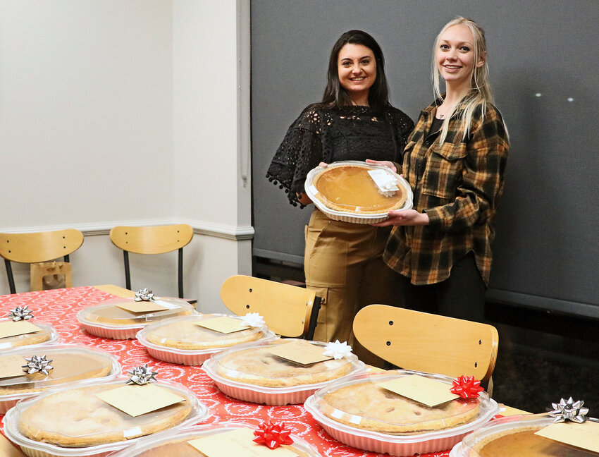 Maggie Valasek, left, and Blair realtor Libby Long pose for a photo with the pies they gifted to Long's past clients Nov. 21 at Scooter's Coffee.