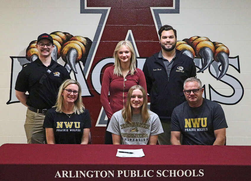 Alongside her family and Fremont coaches, Arlington High School senior Lizzie Meyer signed with the Nebraska Wesleyan swimming team Tuesday.