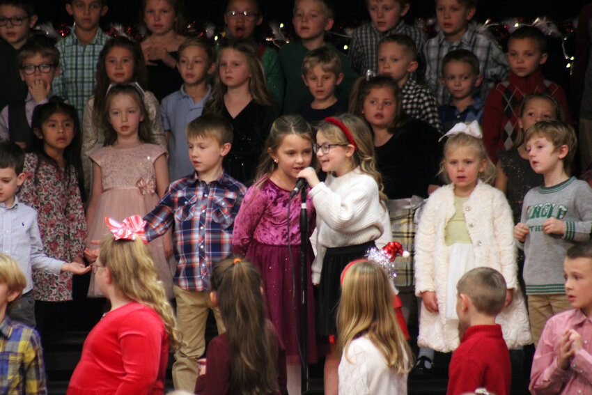 Aubrey Engelbart and Ada Dillon sing a duet during the K-2 students' portion of the winter concert Monday evening.