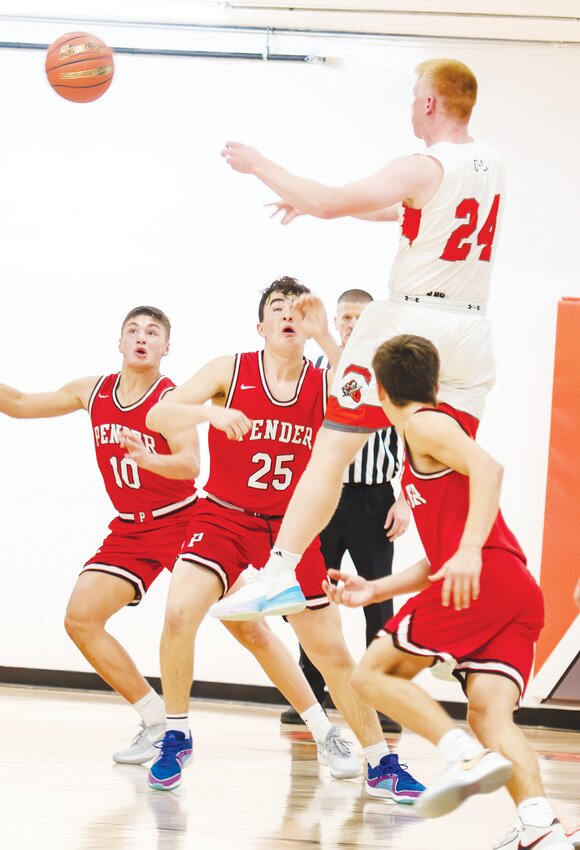 Braylon Anderson fakes a shot to pass the ball beyond the 3-point line to Preston Rost for an attempted shot at the end of the first half against Pender.