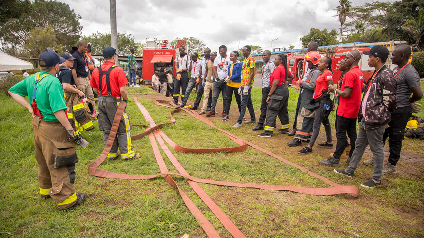 Pictured on Nov. 15, the Nairobi Africa Fire Mission and American firefighters discuss utilizing hoses. Dwyer was one of 17 Americans to take part of a training session in Nairobi, Kenya.