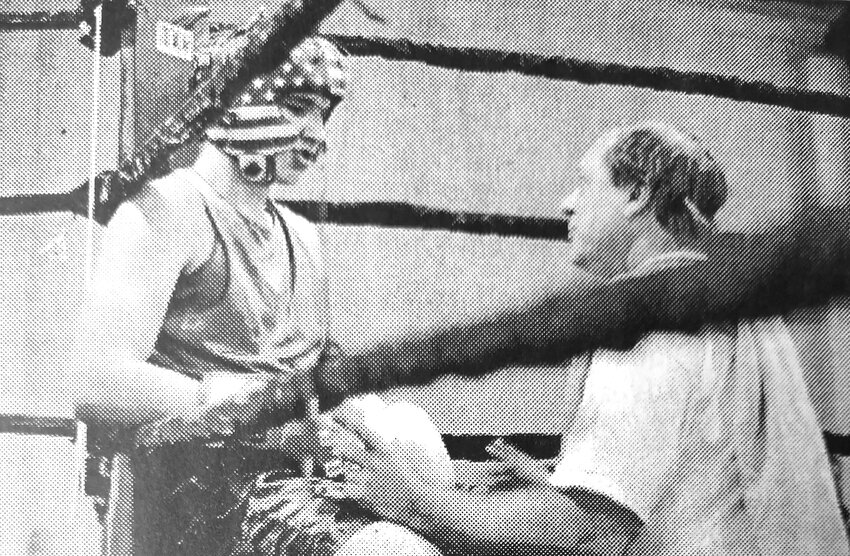 Mike Ronnfeldt of Pierce, left, talks with cornerman Mike Wagner between rounds during a 2001 boxing event in Fort Calhoun.