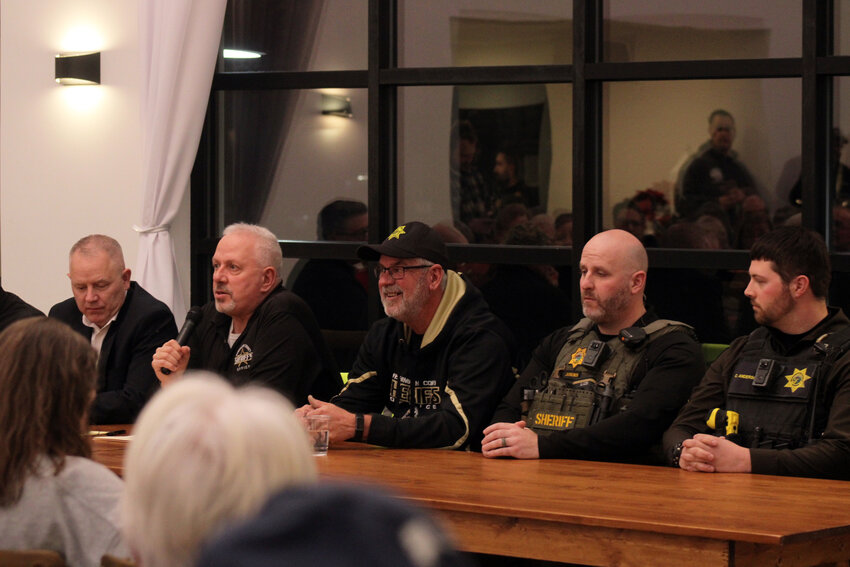 Sheriff Mike Robinson, second from left, addresses a large crown Wednesday evening at Northern Lights Venue in Fort Calhoun during a town hall centered around quelling any fears or concerns residents had over the two homicides that occurred in the city in 2023. Alongside Mike Robinson was Mayor Mitch Robinson; Sgts. Brian Beckman, Cody Anderson, Coltin Bebensee and Alex Judkins; County Board Chairman Steve Dethlefs; Fort Calhoun Councilmember Bob Prieksat; and County Attorney Scott Vander Schaaf.