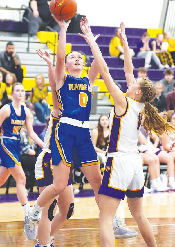 Elli Christianson #0 goes up and over the Tiger defender for the shot and draws the foul against Tekamah-Herman.