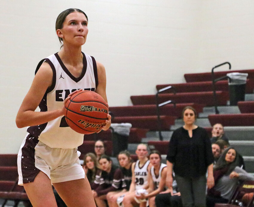 Eagles junior Britt Nielsen takes a free throw attempt as her bench watches Tuesday at Arlington High School.