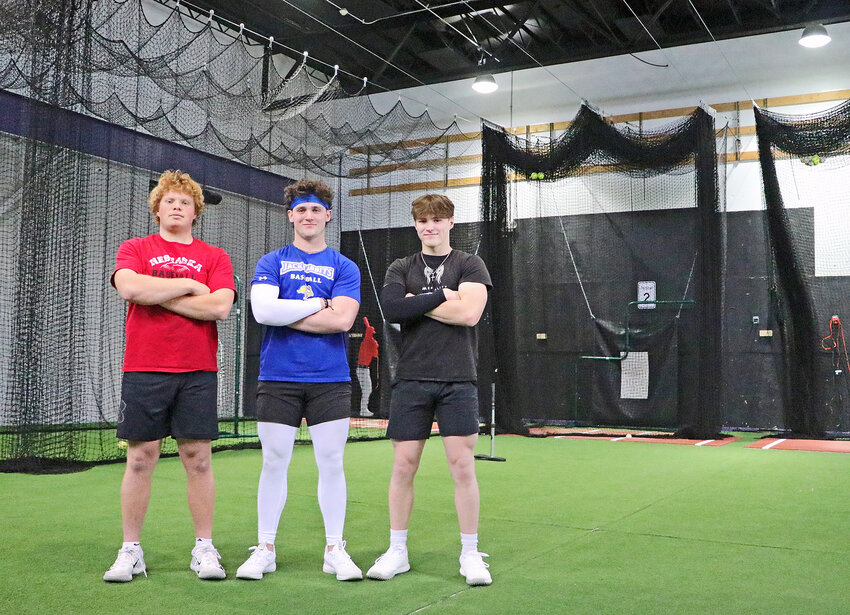 Blair High School baseball players Dylan Swanson, from left, Brady Brown and Tanner Jacobson spent their snow day working on their baseball skills at Blair Training Center on Tuesday.