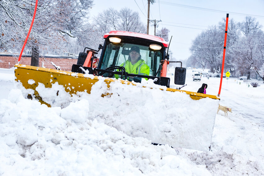 James Bilslend clears the parking area along 16th Street at Steyer Park Tuesday morning.