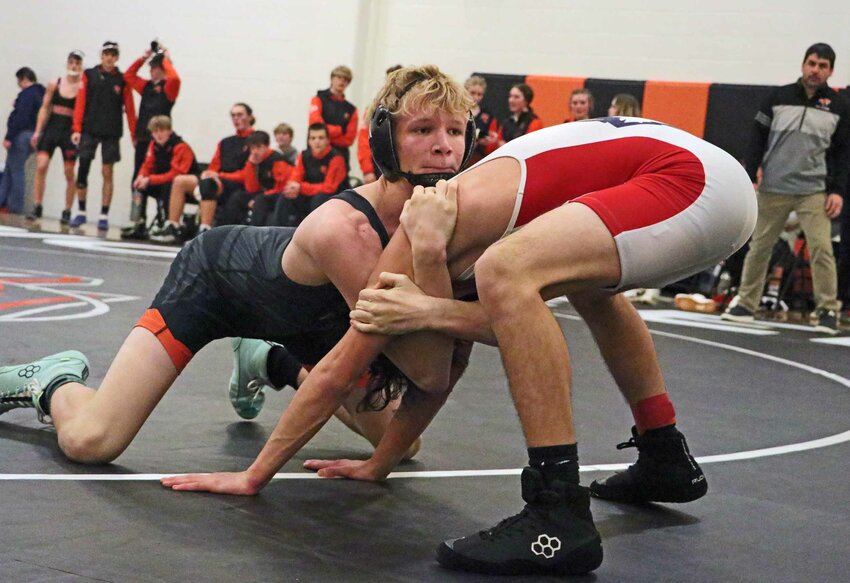 The Pioneers' Gage Nixon, left, attempts to drag his Omaha Northwest opponent down to the mat Tuesday at Fort Calhoun High School.