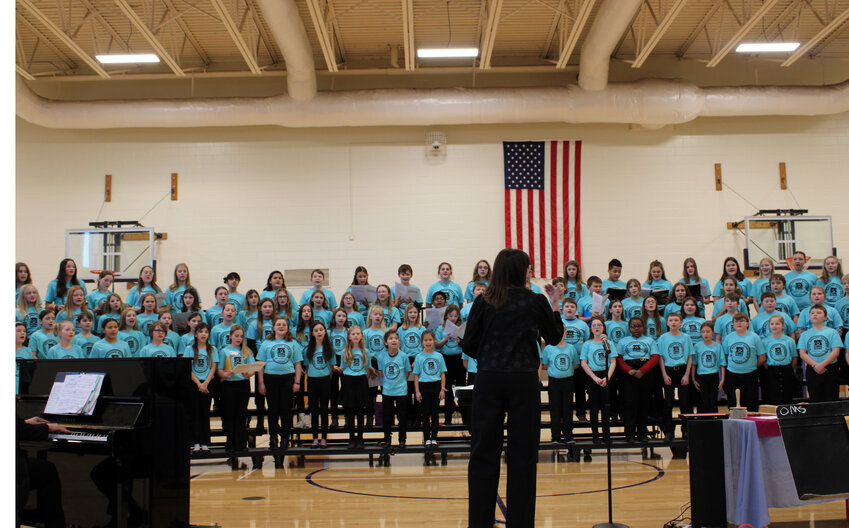 Elizabeth Johnson, a Ph.D. student at UNL, leads the Sing Across Nebraska honor choir Saturday afternoon at Otte Blair Middle School.