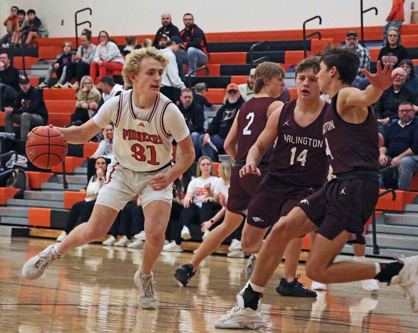 The Pionees' Adam Elofson, left, looks for room to dribble as Arlington's Kieryn Grothe, from left, Oliver Ladehoff and Schuyler Logemann play defense Tuesday during a Nebraska Capitol Conference Tournament game at Fort Calhoun High School.