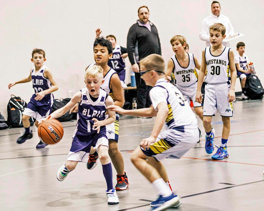 Blair third-grader Gentry McCoy dribbles against the Mustangs on Saturday during Blair Basketball Club's Hoopstock tournament at the Gardner-Hawks Center.